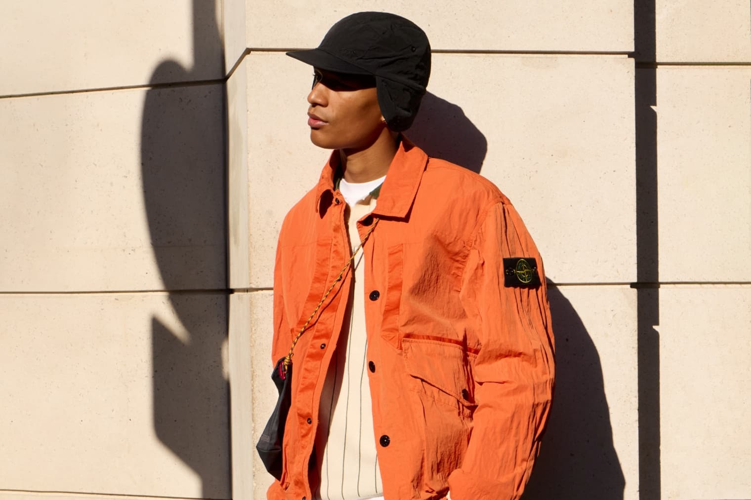 A model wears a Stone Island Nylon-TC Jacket in orange