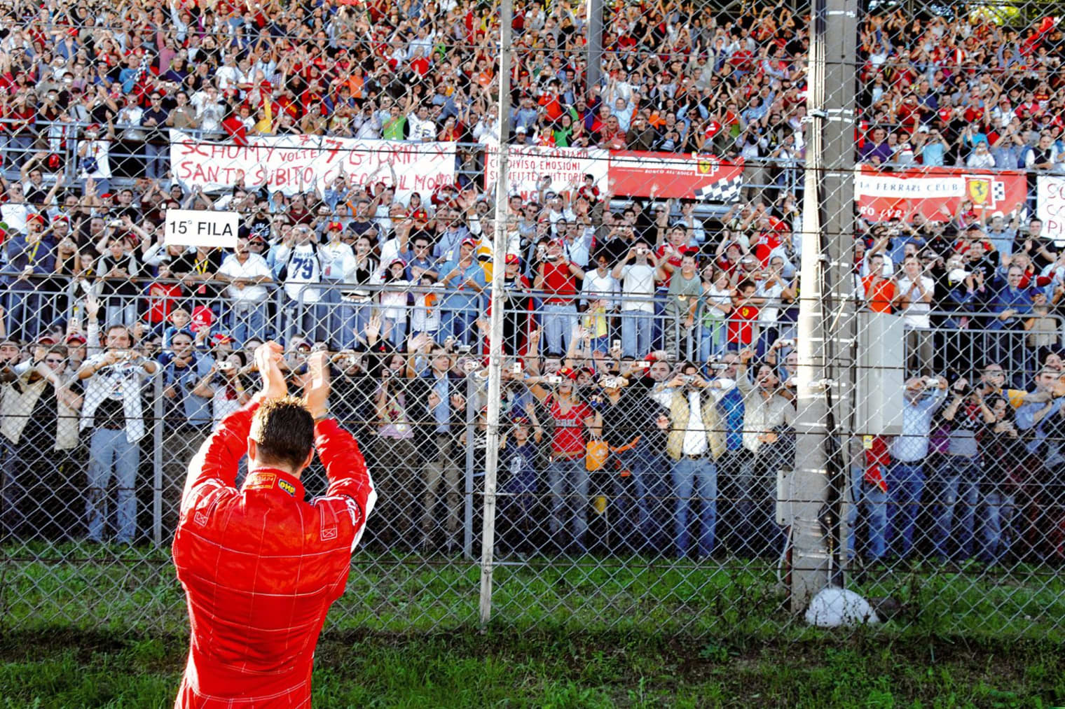 Michael Schumacher celebrates in front of the crowd at Monza
