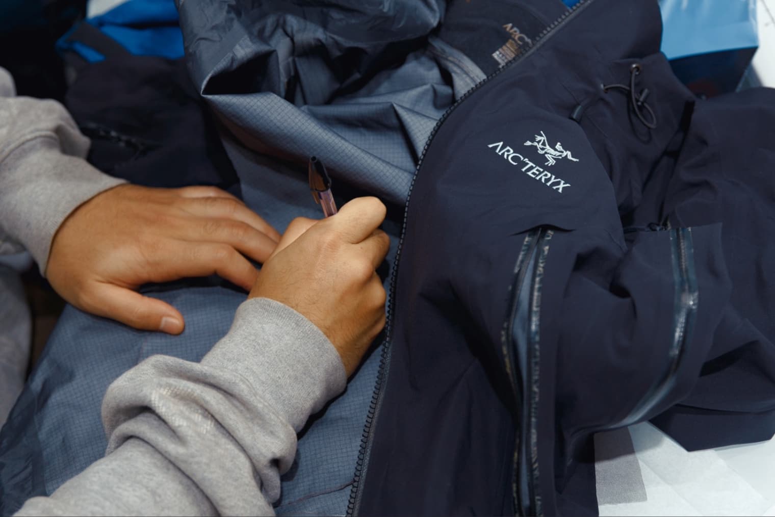 Someone repairs an Arc'teryx jacket
