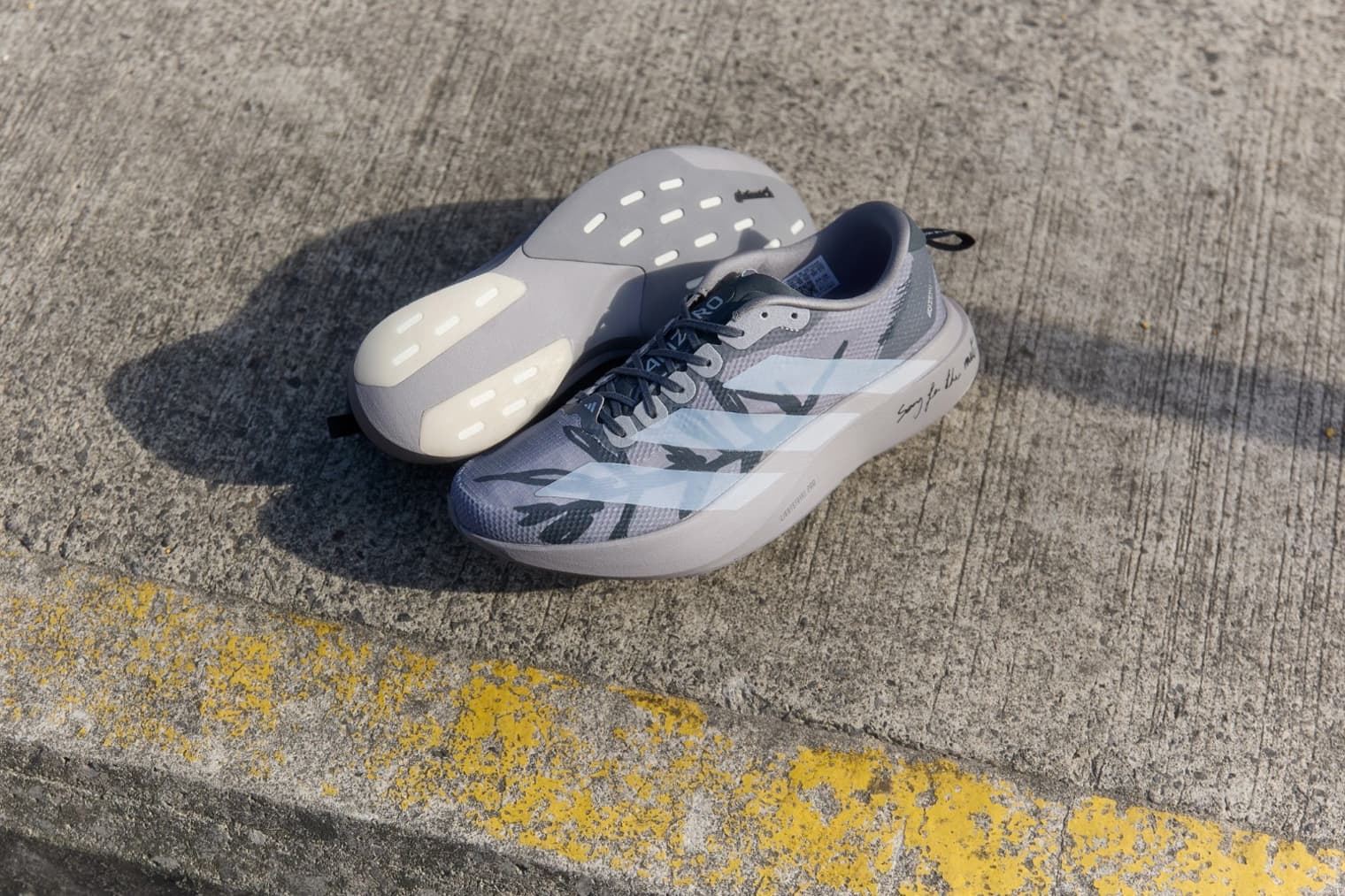 The adidas x Song for the Mute Evo SL on a pavement