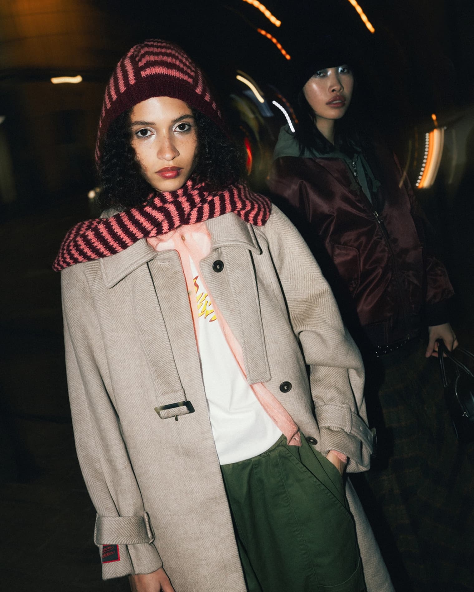 Women wearing Damson Madder wool coat, Dime t-shirt and Tokitom keychain. 