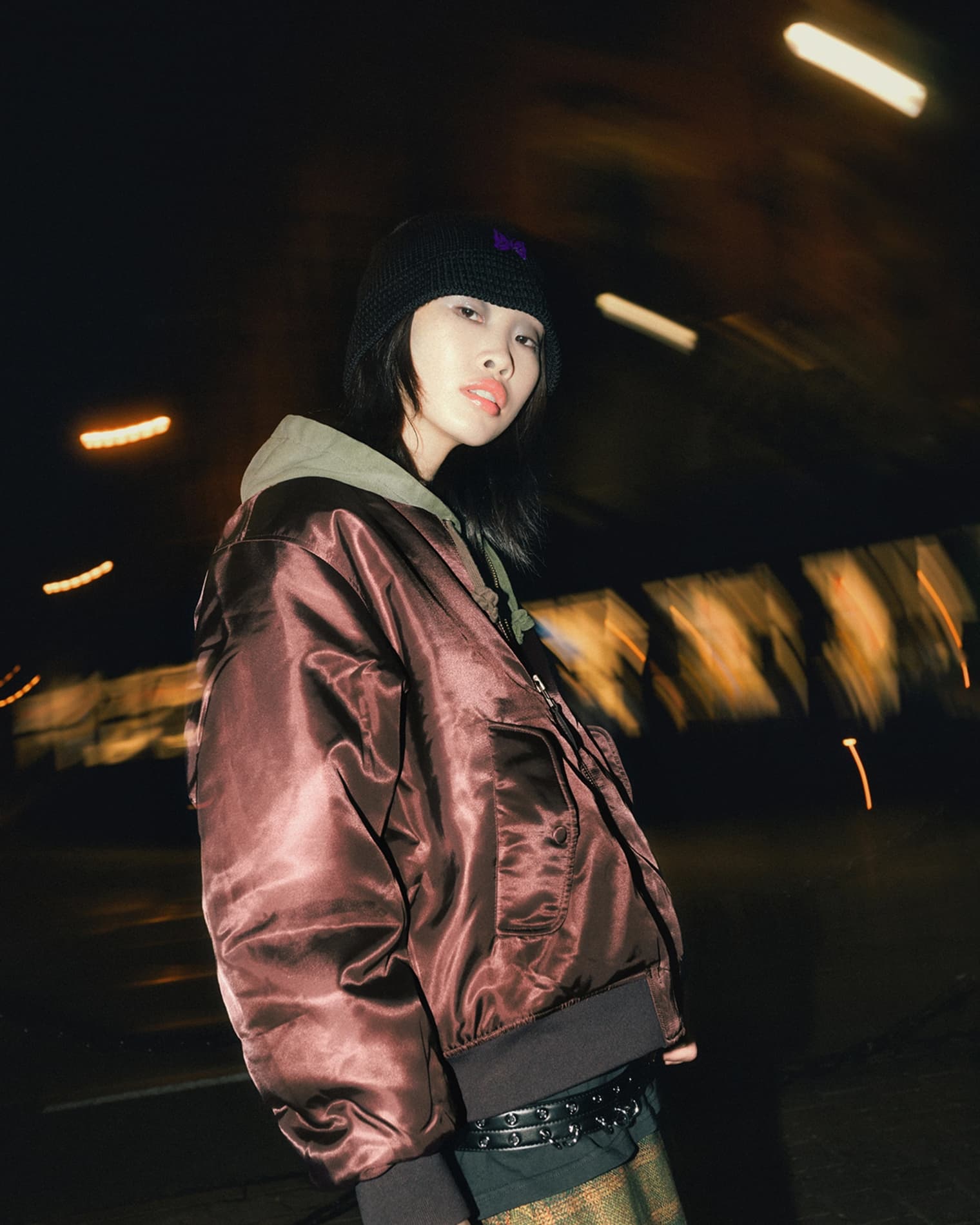 Woman wearing Anine Bing Leon bomber jacket, Our Legacy skirt and Northing Written mini golf bag.