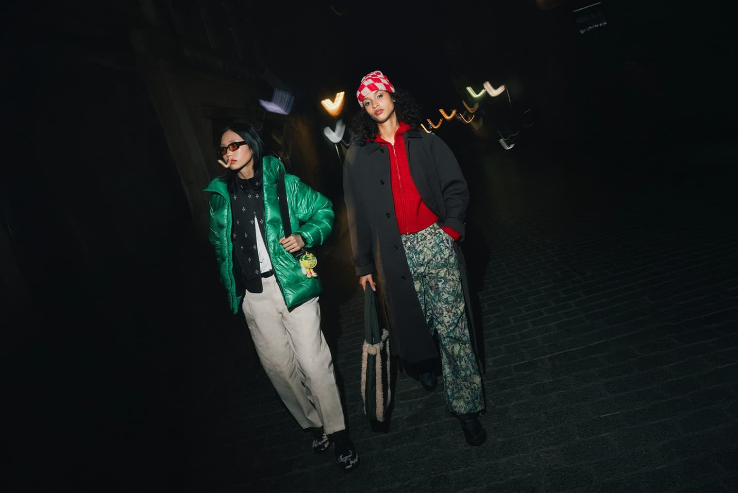 Two women walking wearing North Face Parka coat, Obey zip sweater and Osoi handbag.