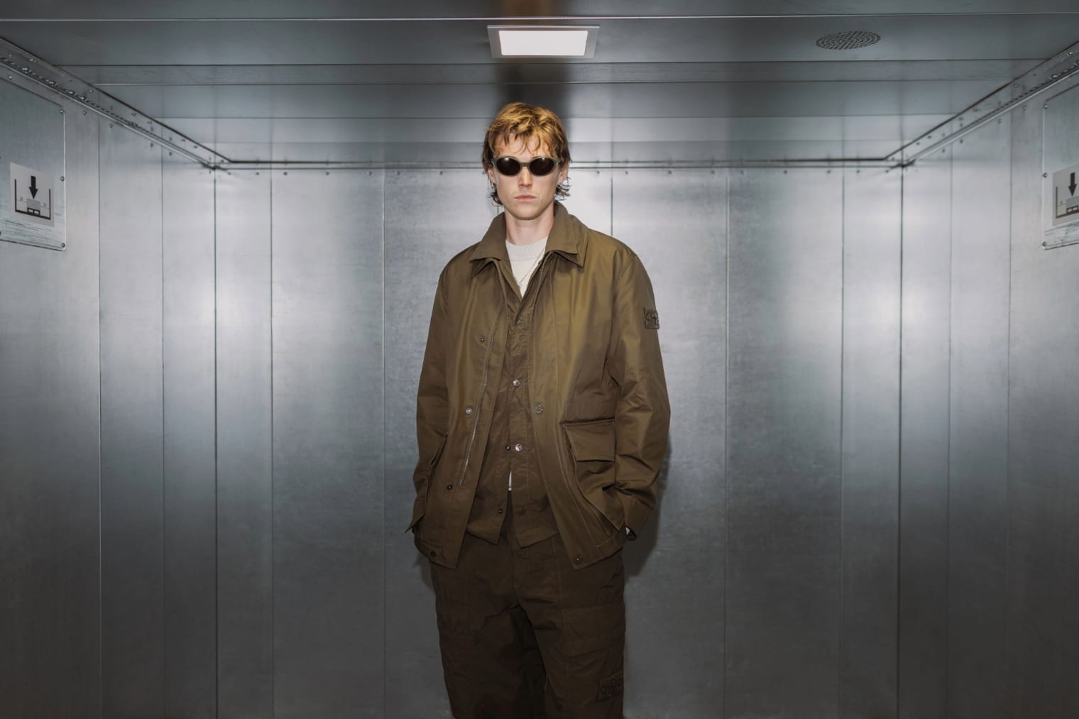 A model wears a Stone Island Ghost Overshirt in brown