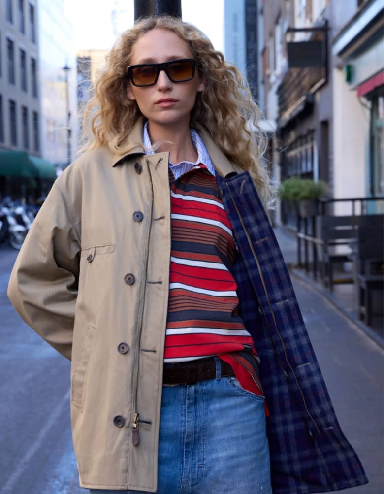 a model wears a damson madder top and Maison Margiela coat