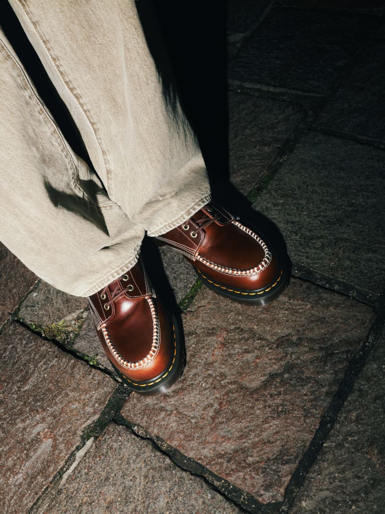 A man wearing Dr. Martens Lowell leather shoe.