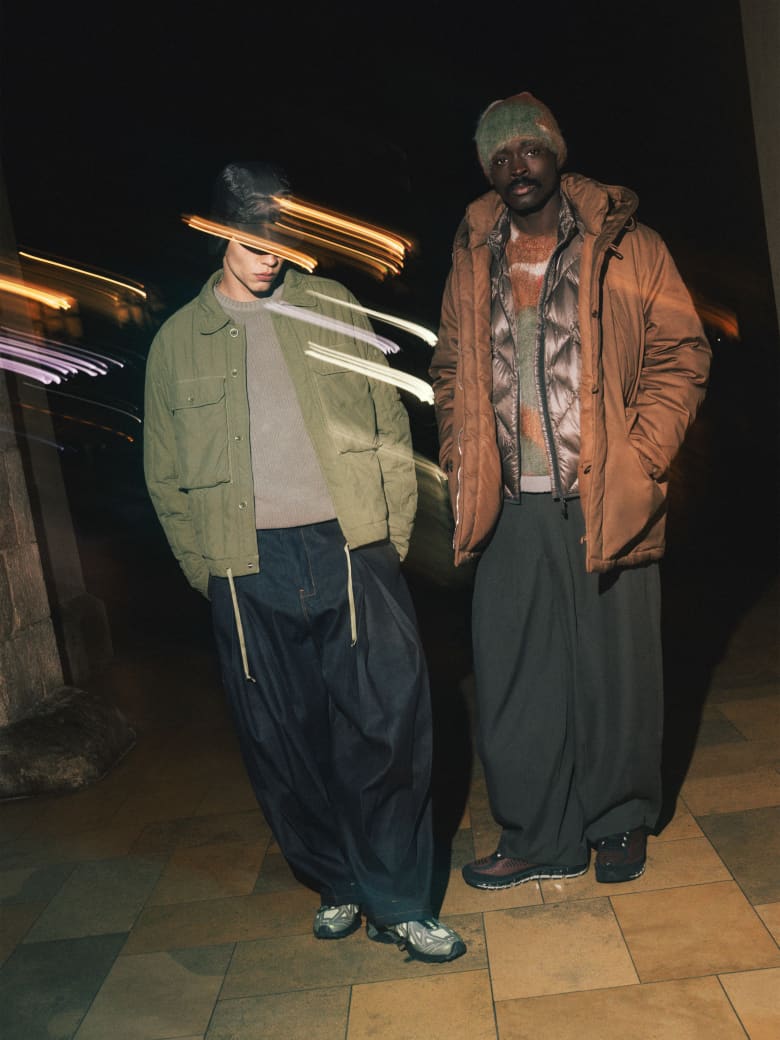 Two men wearing C.P. Company Jacket and jumper, Sage Nation jeans and END. x Salomon sneakers.