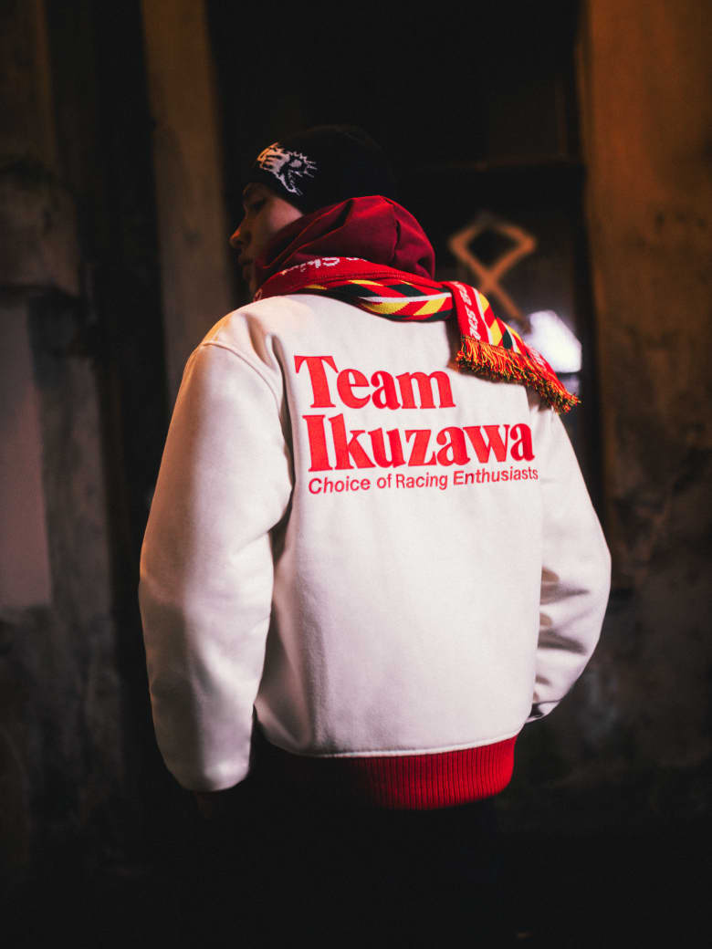 A man wearing Team Ikuzawa jacket, Bene Culture hoodie, Comme Des Garçons SHIRT scarf and Butter Goods beanie. 
