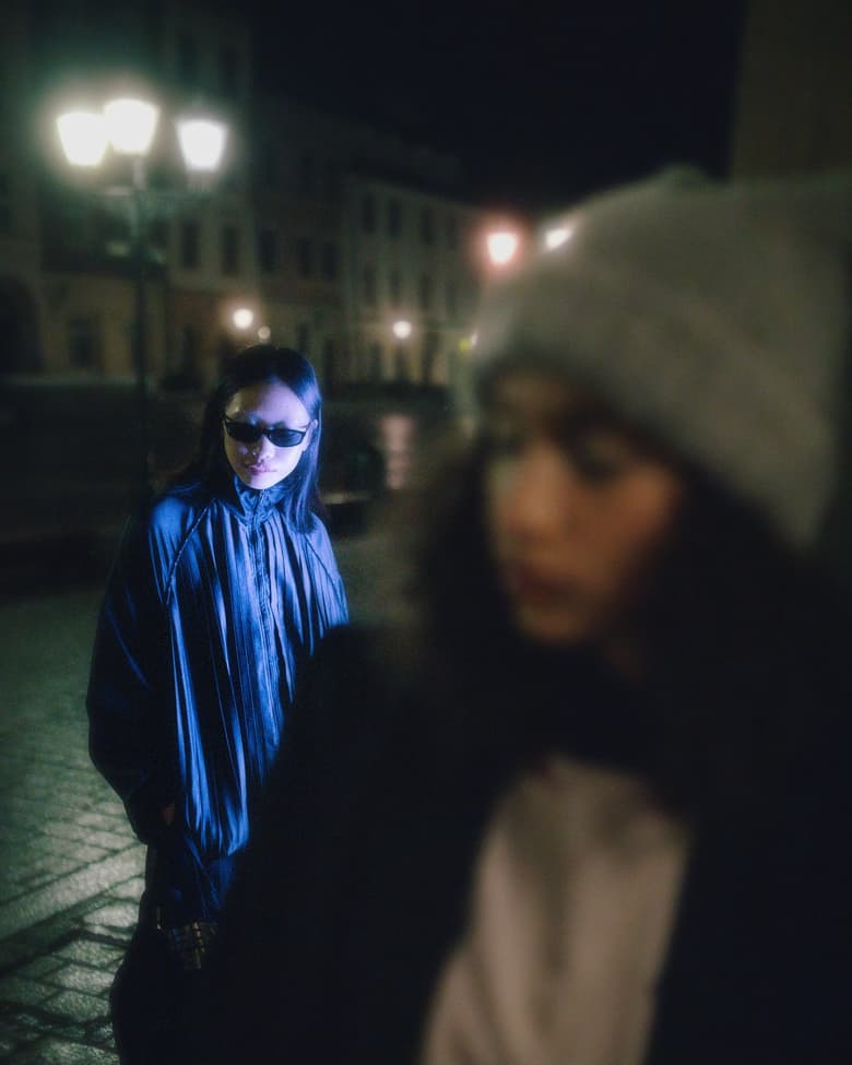 Woman wearing Nike track jacket and Nike track pant.