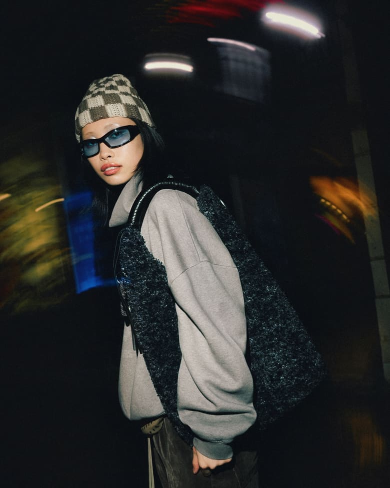 Woman wearing Sundays beanie, Rick Owens trousers, and Acne Studios sweat.