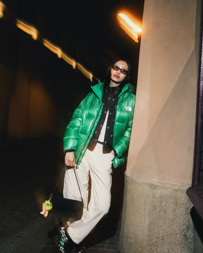 Woman stood wearing Needles track jacket, Adidas Samba, Gramicci pants and Cecilie Bahnsen t-shirt.