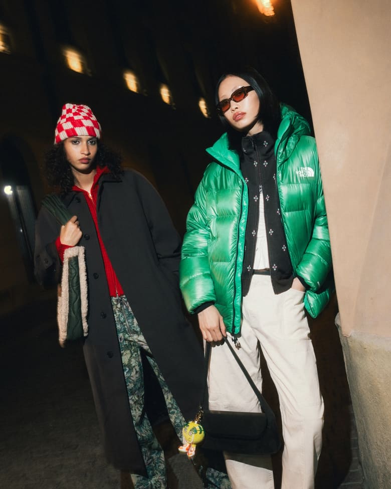 Two women stood wearing Sundays beanie, Ganni pants and Our Legacy sunglasses.
