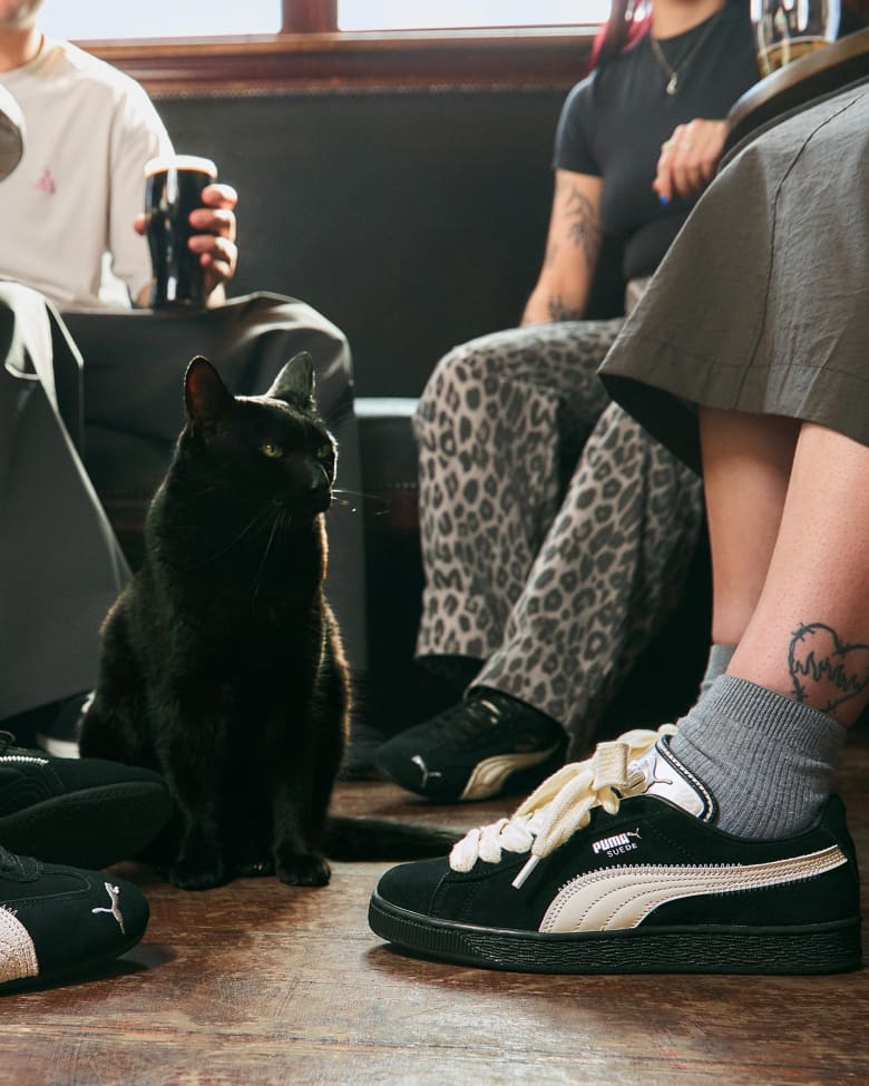 Two people wearing the end Puma speedcat and suede sneakers in black and white.