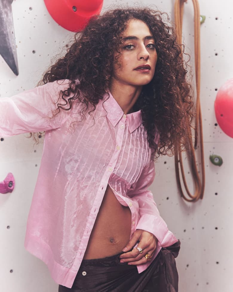 Deba Hekmat wearing a pink Damson Madder Presented by END. Shirt