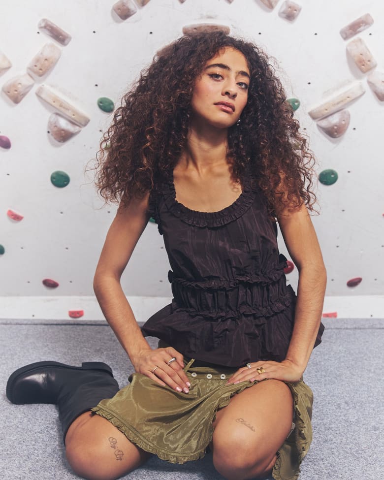 Deba Hekmat kneeling down wearing Damson Madder Presented by END.