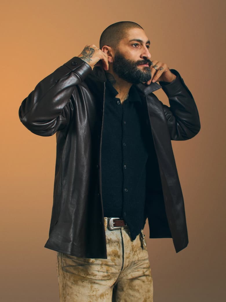 A man wearing a black leather jacket. 