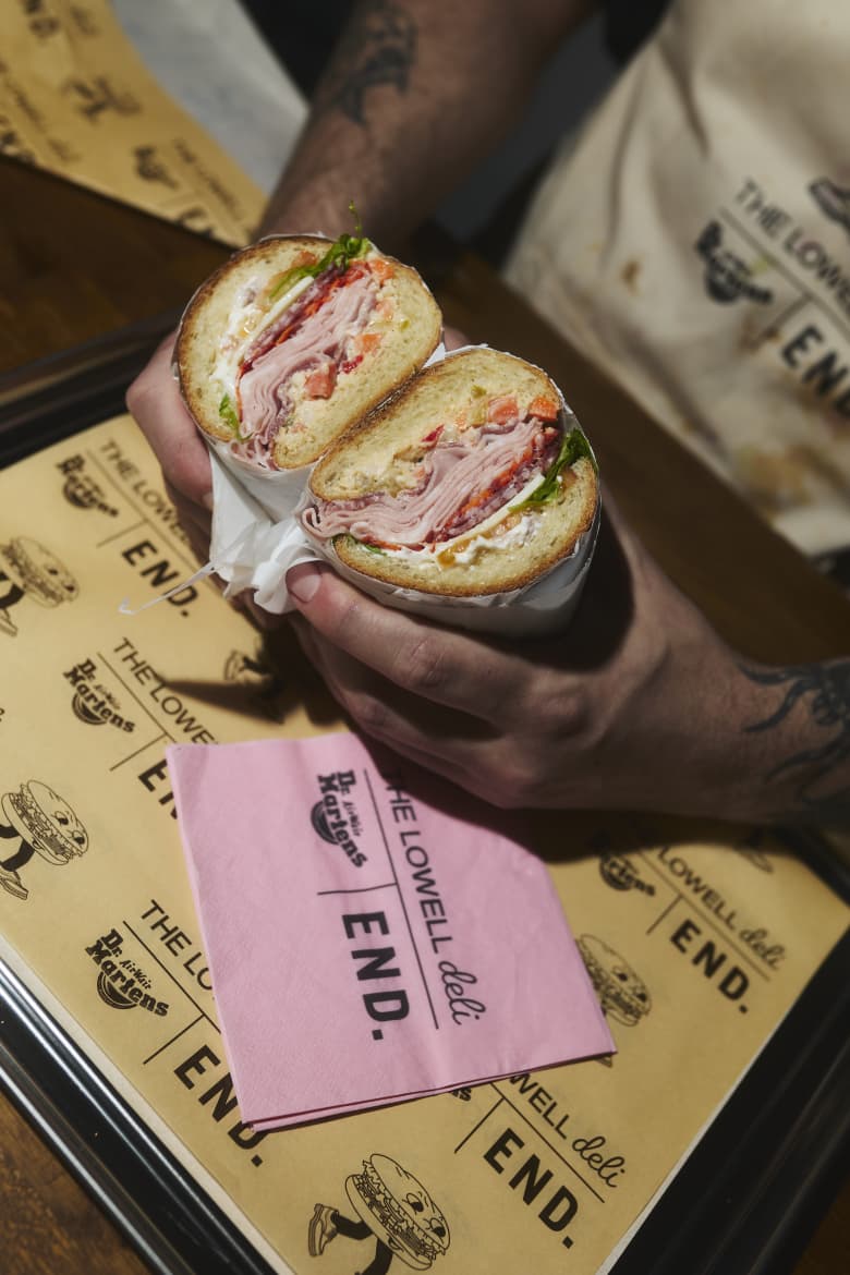 A cross-section of a sandwich showing the filling with END. and Dr. Martens branded paper beneath.