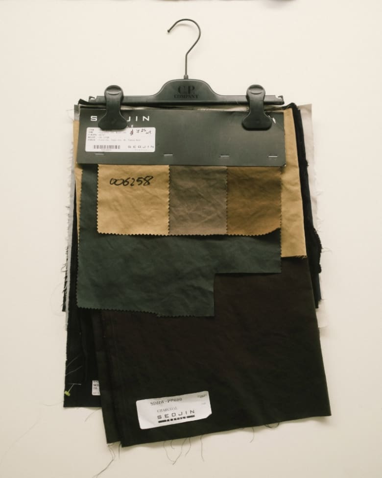 swatches of fabric on a hanger in a workshop