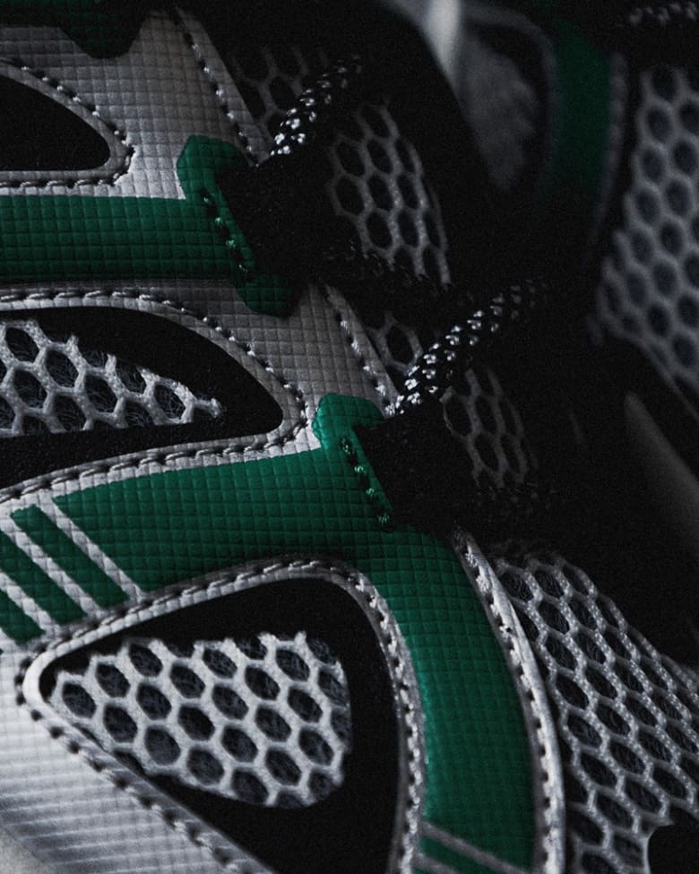 a close up of Anima sneakers in silver and green