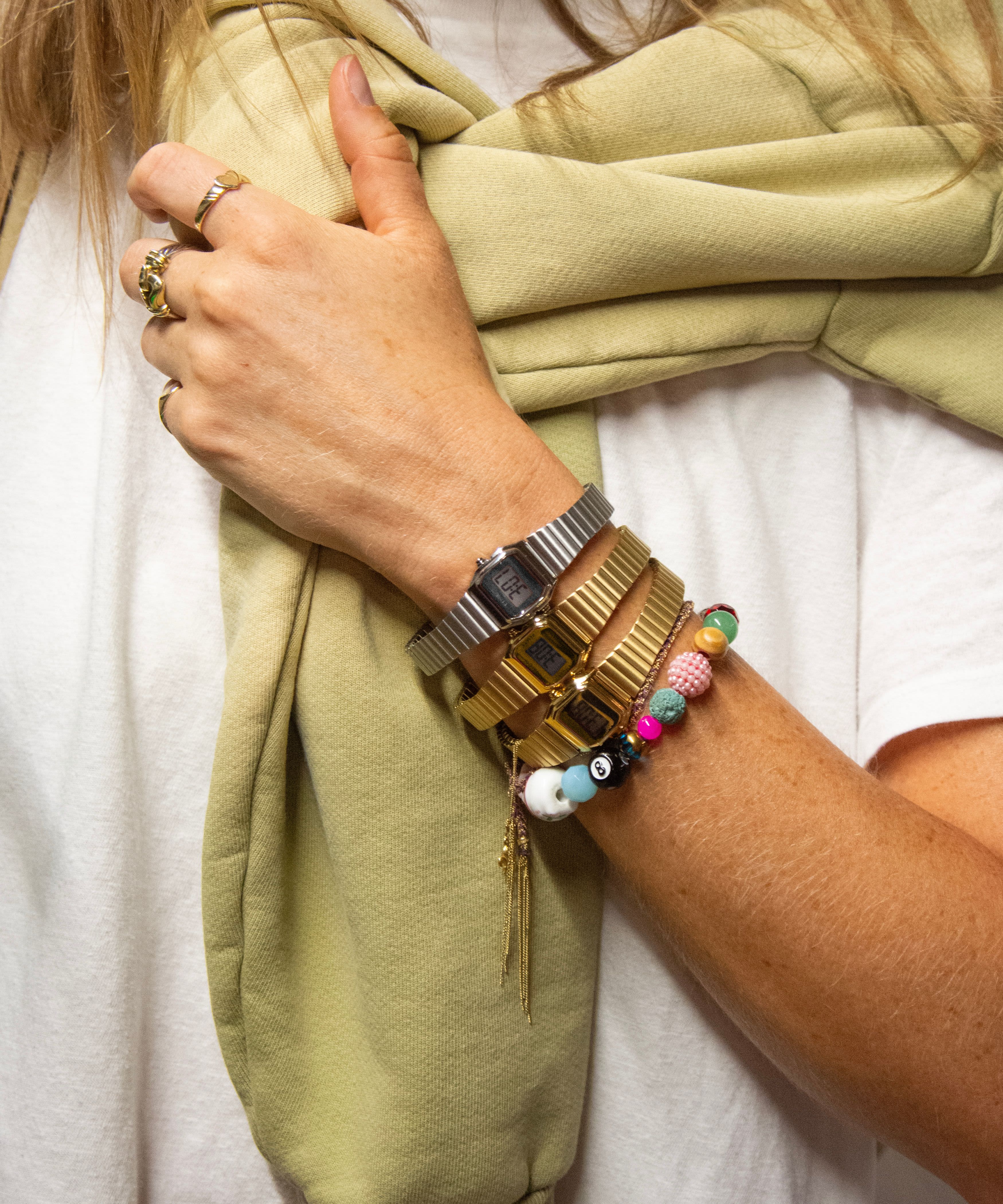 A woman wearing two Timex watches on her wrist. 