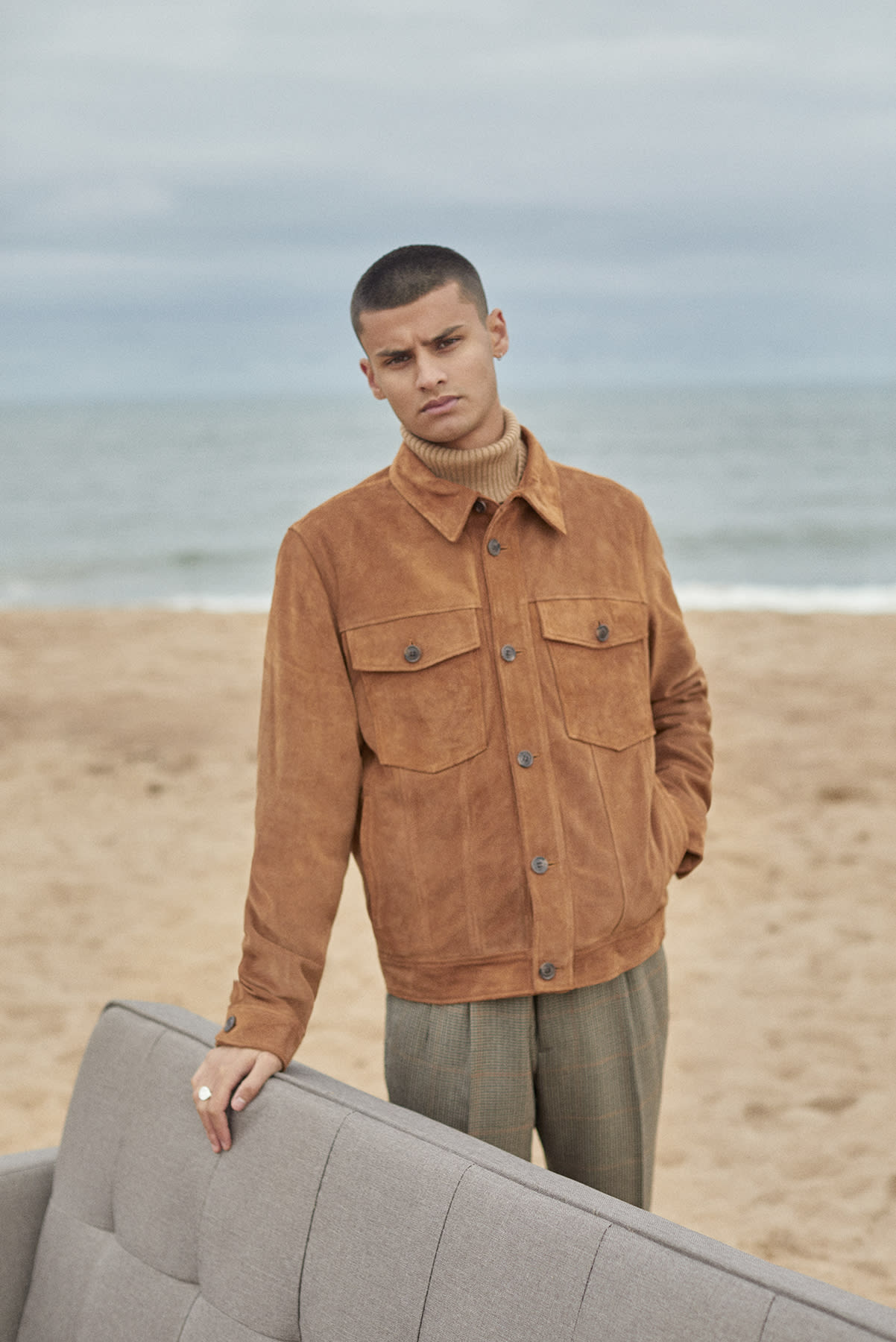 Suede A.P.C. jacket worn for Bare Minimum END. editorial on sofa at the beach
