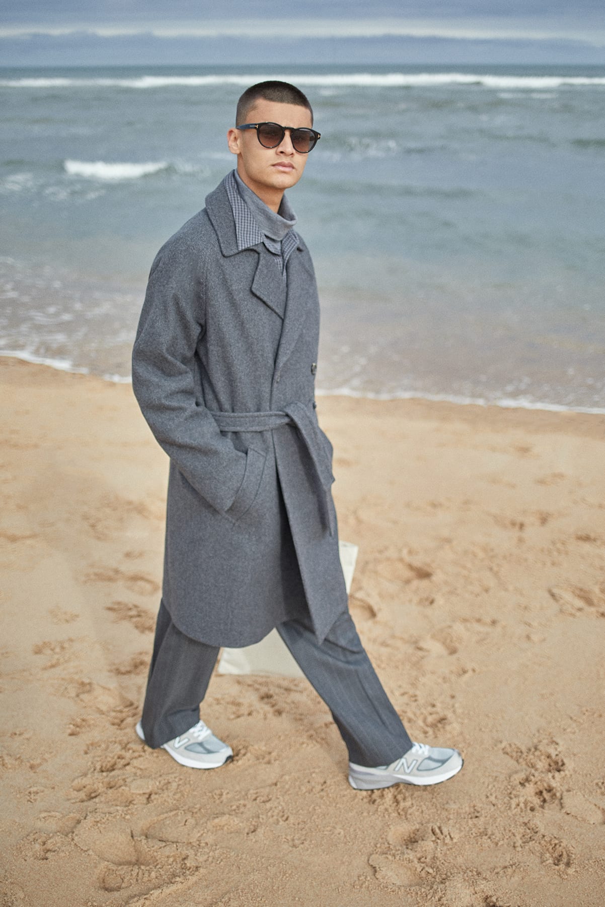 A.P.C. coat worn at the beach for Bare Minimum END. editorial