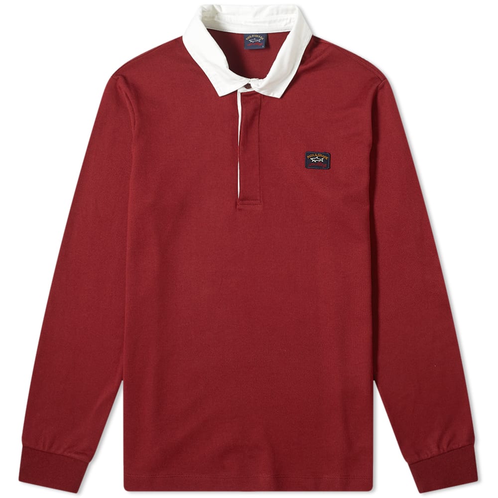 Made in Italy with a pitch-ready look in mind, this deep burgundy rugby shirt is a Paul & Shark staple. Cut from pure cotton and trimmed with a contrasting twill collar, its athletic build is secured with a concealed placket that’s flanked by a woven brand patch. 
 
100% Cotton 
Contrast Collar 
3 Button Placket 
Ribbed Cuffs 
Woven Brand Patch 
Made in Italy