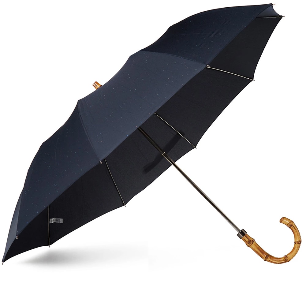 London Undercover designer Jamie Milestone is a man who believes the humble umbrella is not receiving the recognition it deserves. A practical, stylish and quintessentially British accessory, London Undercover's expertly executed Umbrella's are constructed using age old techniques and are seen as a canvas for endless amounts of expression. A satisfyingly sophisticated take on an indispensable accessory. 
The City Fleck Telescopic Umbrella seeks to combine the quality and reliability of their full size models with an incredibly versatile folded design, and succeeds. A contemporary reworking of a classic accessory, it features a natural whangee bamboo handle, finished with a stylish fleck print. 

Handmade Two Section Folding Design
Whangee Bamboo Handle
Coated Metal Construction
Laser Etched Logo Tag
Comes with Cover