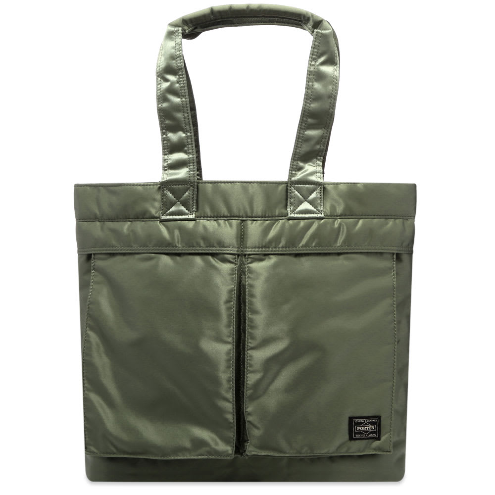Made in Japan, this portable tote bag is sure to bring an element of Tokyo cool into your day-to-day rotation. Carrying Porter-Yoshida & Co.’s iconic utilitarian aesthetic through into the new season, the durable sage green bag has a pair of functional carry handles and one of its two practical front pockets is topped with a signature logo patch.

100% Nylon
2 Front Pockets
Woven Brand Patch 
2 Carry Handles
Made in Japan