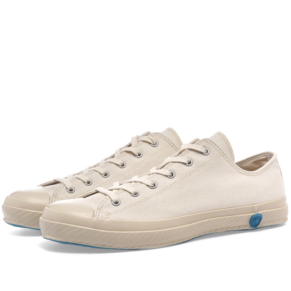 Made by a handful of skilled manufacturers in Japan Shoes Like Pottery utilises a unique vulcanising process when crafting its canvas sneakers. Named 'ka-ryu' in Japanese, this signature process involves each pair of shoes undergoing a kiln-fired treatment, giving their rubber soles a uniquely flexible and highly durable finish. As classic as they come, this white canvas pair are finished off with a wax stamp style sole decal at each heel.

Canvas Uppers
Rubber Toe Cap
Rubberised Brand Stamp 
Vulcanised Rubber Outsole 
Made in Japan