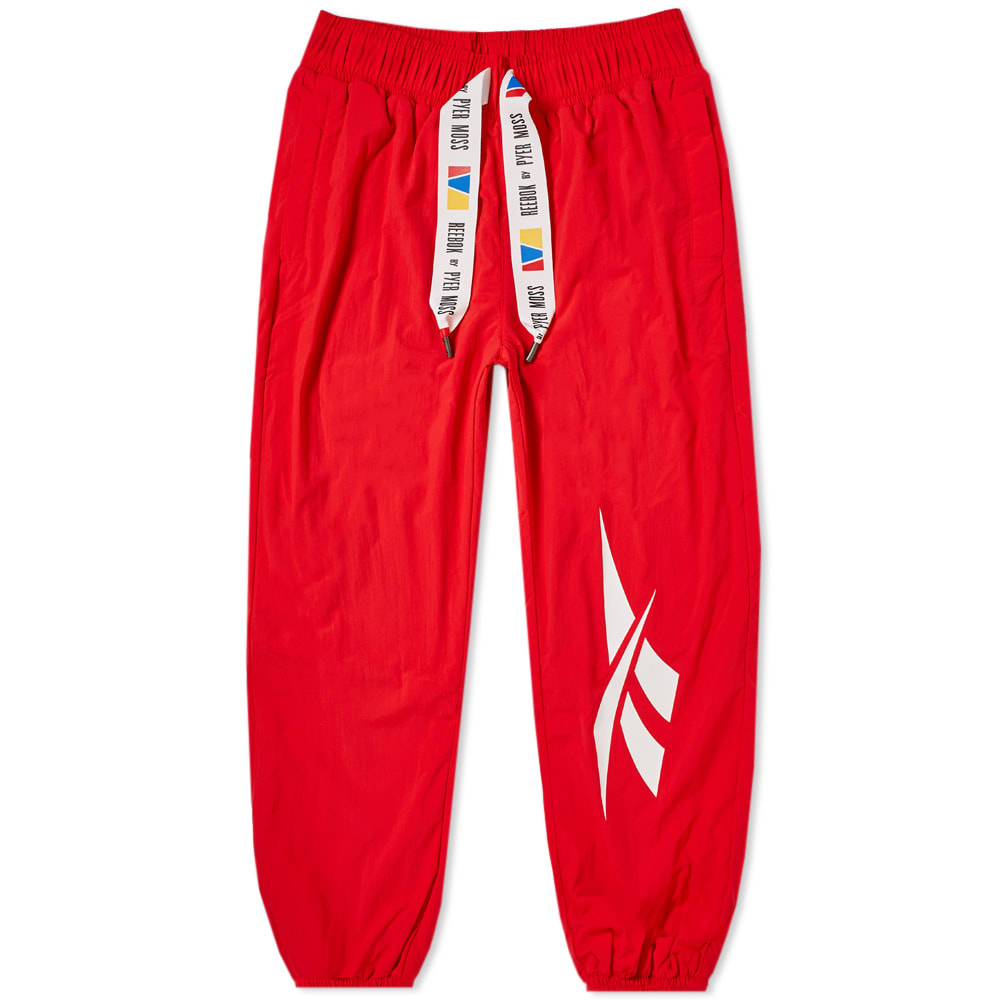 This season sees Pyer Moss showcase a contemporary take on an iconic Reebok sportswear style. Built with a relaxed fit in mind, this polyester pair of ‘Crinkle’ joggers are delivered in a bold red colourway and are accented with a bold drawstring adjustment at the waist. Inspired by a history of counter culture, this sporting style is kitted out with a total of four functional pockets and is branded with an iconic vector graphic at the leg.

100% Polyester
Relaxed Fit
Elasticated Drawstring Waist 
2 Side Entry Pockets
2 Back Patch Pockets
‘Flag Badge’ Appliqué
Printed Branding
Elasticated Cuffs