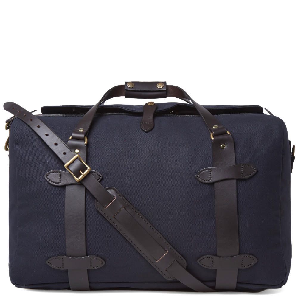 Filson, one of America’s most revered brands, have been producing their renowned offering since 1897. Each bag in their collection is supplied with a lifetime guarantee, testament to the Seattle-based brand’s belief in their finely crafted, durable pieces.Built from a rain-resistant twill and bridle leather, the Medium Duffle Bag has been specially designed to comply with hand luggage requirements. Equipped with a rustproof brass zipper, storm flap for added protection and an adjustable removeable leather carry strap.

Shower-Proof Twill Construction
Bridle Leather Straps
Detachable Leather Shoulder Strap
Solid Brass Zipper
2 Interior Pockets
Made In The USA