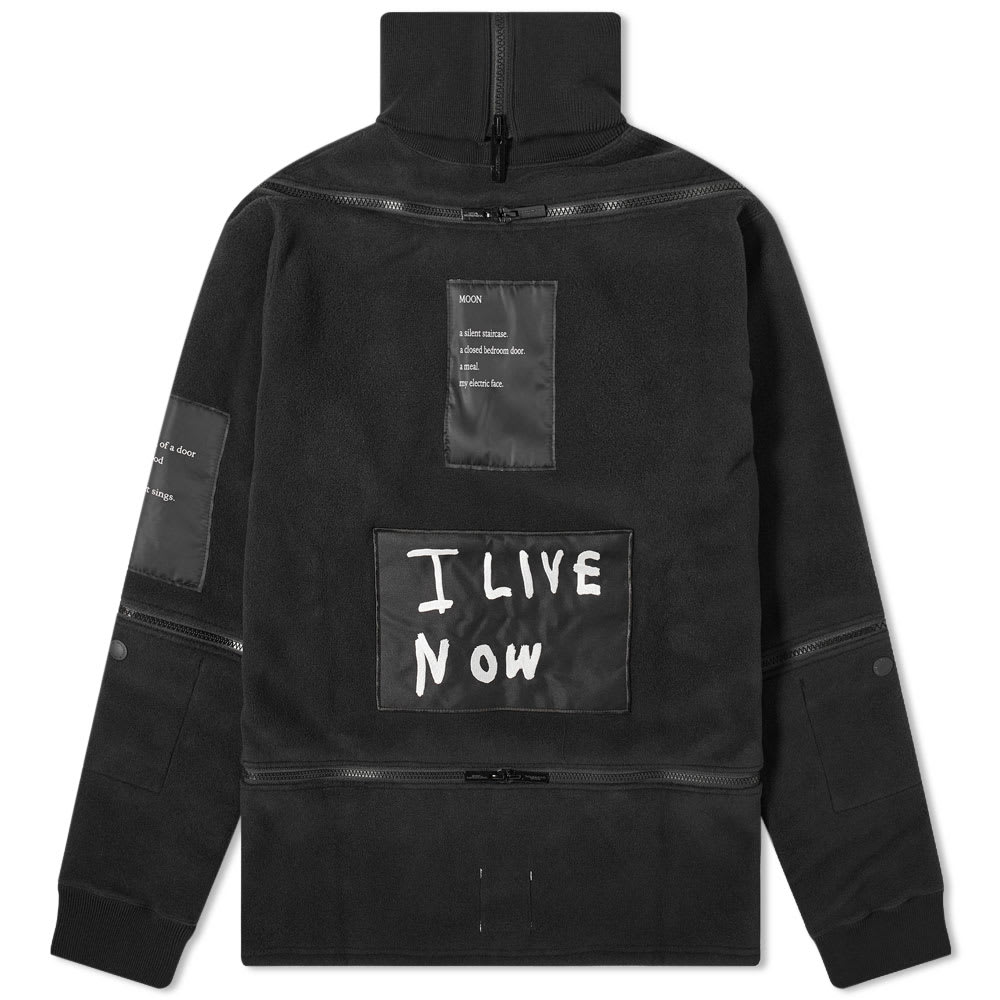 A multi-zippered piece that’s sure to turn heads, this fleece from TAKAHIROMIYASHITATheSoloist. is fitted with a cosy roll neckline. Made in Japan, its all-black build acts as a canvas for poetry and is completed with a bold ‘I LIVE NOW’ slogan patch at the back.

100% Polyester
Fleece Fabric
Roll Neck 
Zip Detailing
Made in Japan