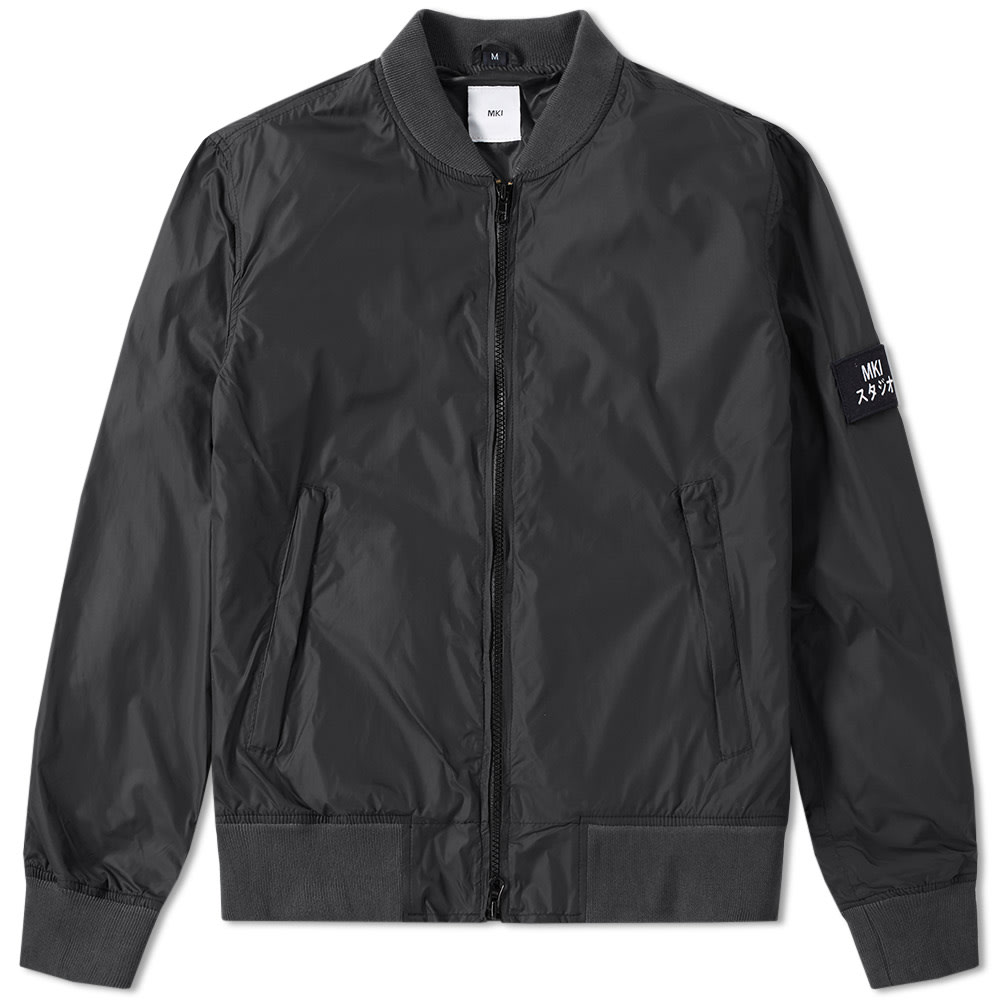 The MKI collections are created to be both accessible in wear-ability and affordability; gaining mass reputation as a brand for adopting elements from the Japanese youth tribe who loitered in the upscale Ginza shopping neighbourhood. Influenced by the American collegiate style, this Badge Bomber has been given a contemporary update with the streetwear style of the Leeds-based store. Cut from a lightweight nylon an ribbed trims, it takes its design cues from the original with a two-way zip closure, zipped pockets to either side and an MKI felt patch to the sleeve.

100% Nylon Shell
Lightweight Lining
2 Way Zip Closure
Ribbed Collar, Cuffs & Hem