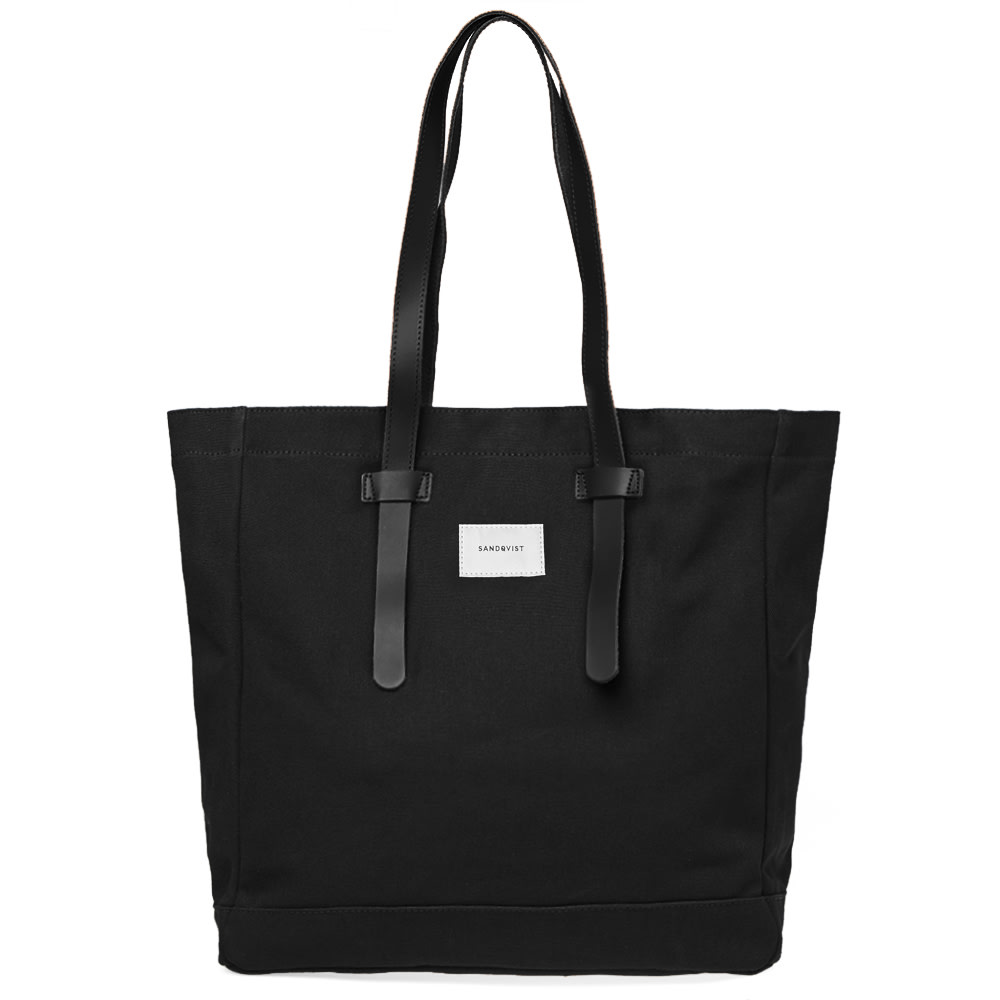 Cut from a robust cotton canvas, Nordic-natives Sandqvist deliver this blacked-out Stig tote bag this season. Trimmed with leather straps, this untreated canvas bag is signed off with a woven logo patch at the front and is kitted out with a single zipped pocket at the interior.

100% Cotton
Untreated Canvas
Leather Straps
Interior Zip Pocket
Woven Logo Patch