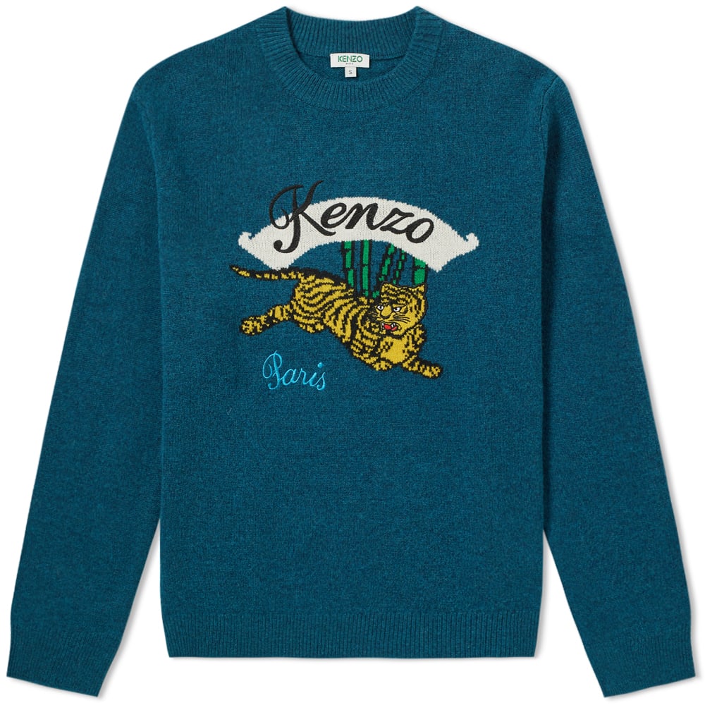 Striving to entail Kenzo Takada’s eclectic energy, the tiger crewneck knit sees the brand’s bamboo setting engineered to the chest, featuring the jumping tiger mascot embroidered atop of the petrol blue base. Cut from cosy wool, the casual fit construction is framed by ribbed trimmings at the neck, cuffs and hem. Seek to reinvent your sportswear style with the aid of one of Paris’ most sought-after luxury brands.

100% Wool
Embroidered Branding
Engineered Jumping Tiger
Ribbed Crewneck, Cuffs & Hem