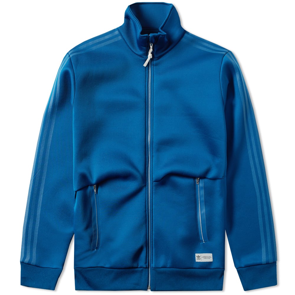 adidas update a minimal style from the '70s Freizeit collection with premium fabrics, zip pockets, and a reflective Trefoil label. Offering an archival-inspired style, the cool, breathable track top has been cut from a cotton front and airy nylon back to ensure optimum comfort.

100% Cotton Front
Breathable Nylon Rear
Tonal 3-Stripes
Laser Cut Collar & Pocket Details
Full Metallic Zip
Stand-Up Collar
Style Code: AY8525
