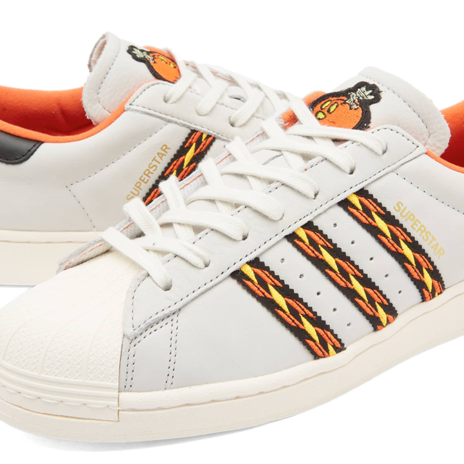 orange and white adidas superstar