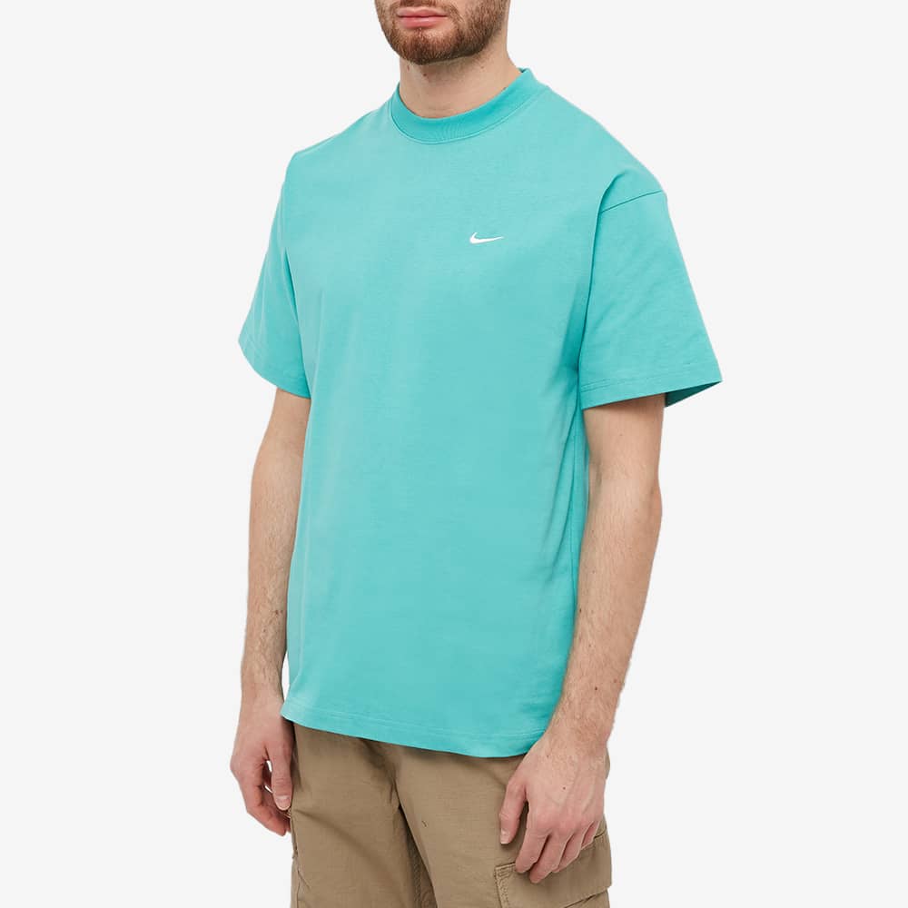 white nike shoes with teal swoosh