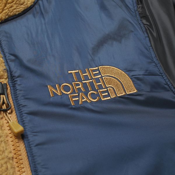 black and gold north face vest